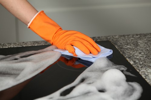 Professional home cleaners working in a Kensington W8 living room